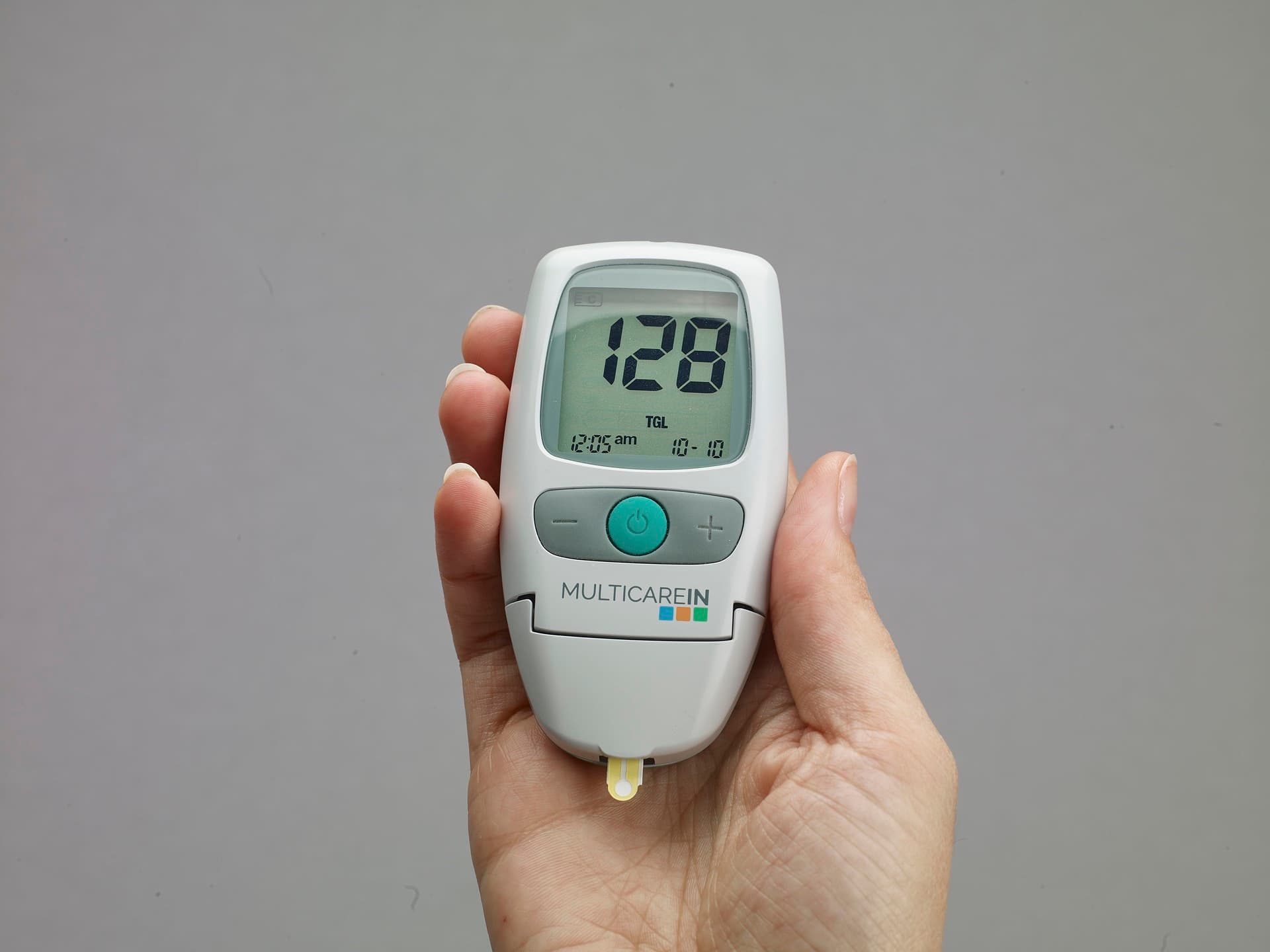this picture shows someone undertaking biometric screening what is. a hand is holding a monitor.